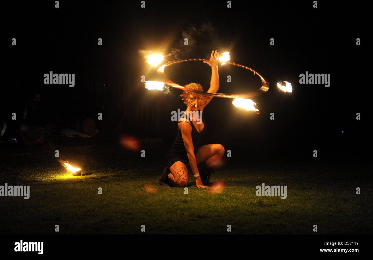 Paarl, South Africa. 24th March, 2013. A fire dancer performs during the Earth hour picnic at the Afrikaanse Taalmonument on March 24, 2013. Earth Hour is an annual worldwide event to help raise awareness about the need to take action on environmental issues. Credit: Lulama Zenzile/Foto24/Gallo Images/ Alamy Live News Stock Photo