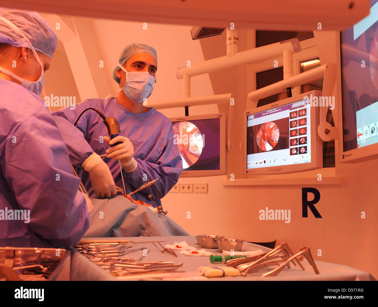 A file picture dated 11 March 2010 of Surgeon Gero Strauss (R) operating on a patient's nose under red light in a worldwide unique hightech operating room of International Reference and Development Centre for Surgical Technology (IRDC) in Leipzig, Germany. The operating room cooperates with Technichal University Munich and University Leipzig. Photo: WALTRAUD GRUBITZSCH Stock Photo