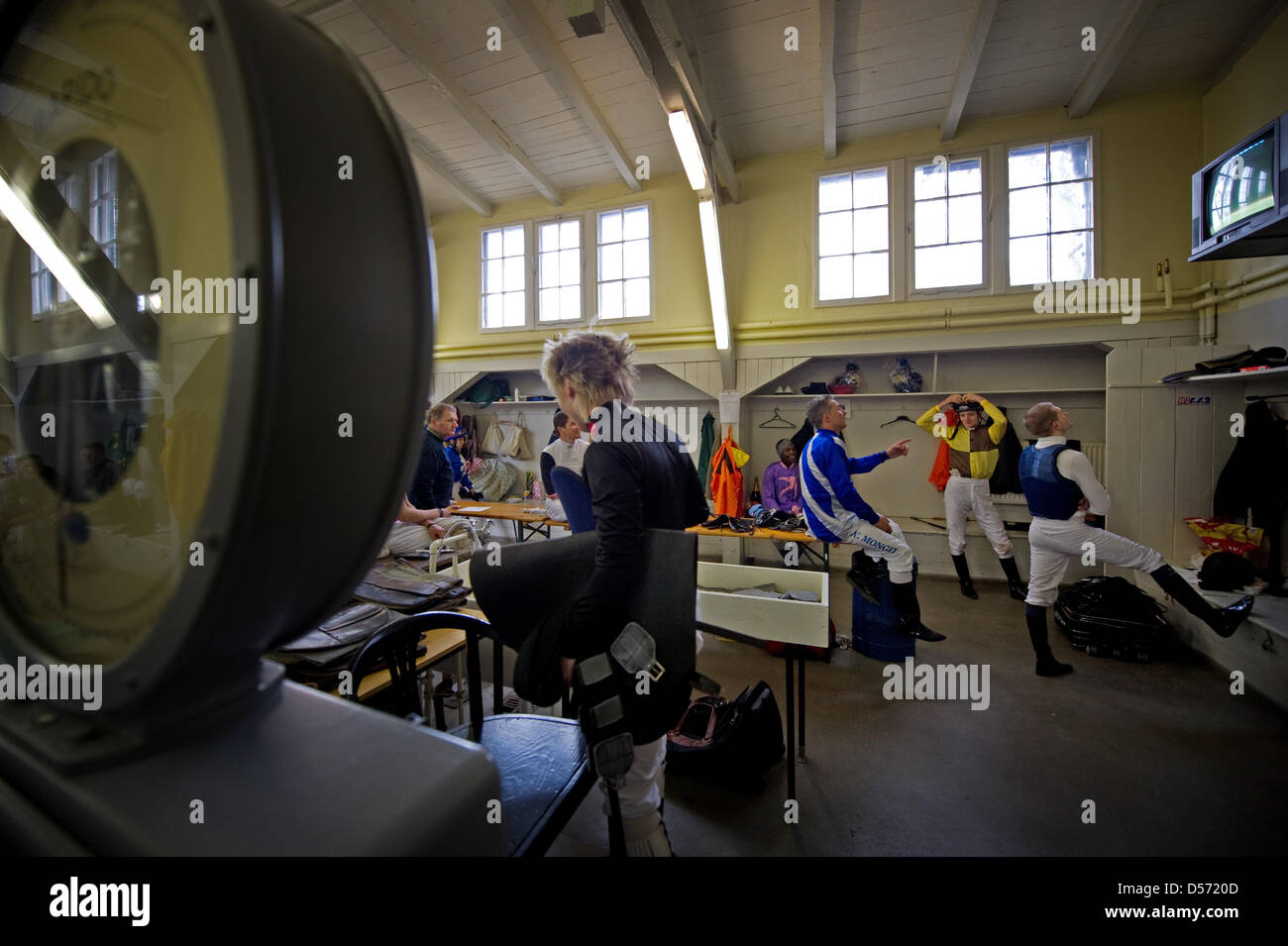 Jockeys wait for their race in the locker room at the horse race track in Hoppegarten, Brandenburg, Germany, 04 April 2010. The 142nd racing season kicked off with seven races over the weekend. Photo: Arno Burgi Stock Photo