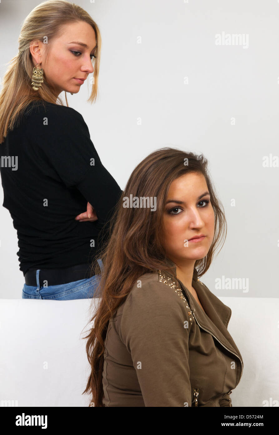 Two young adult women having an argument at home Stock Photo