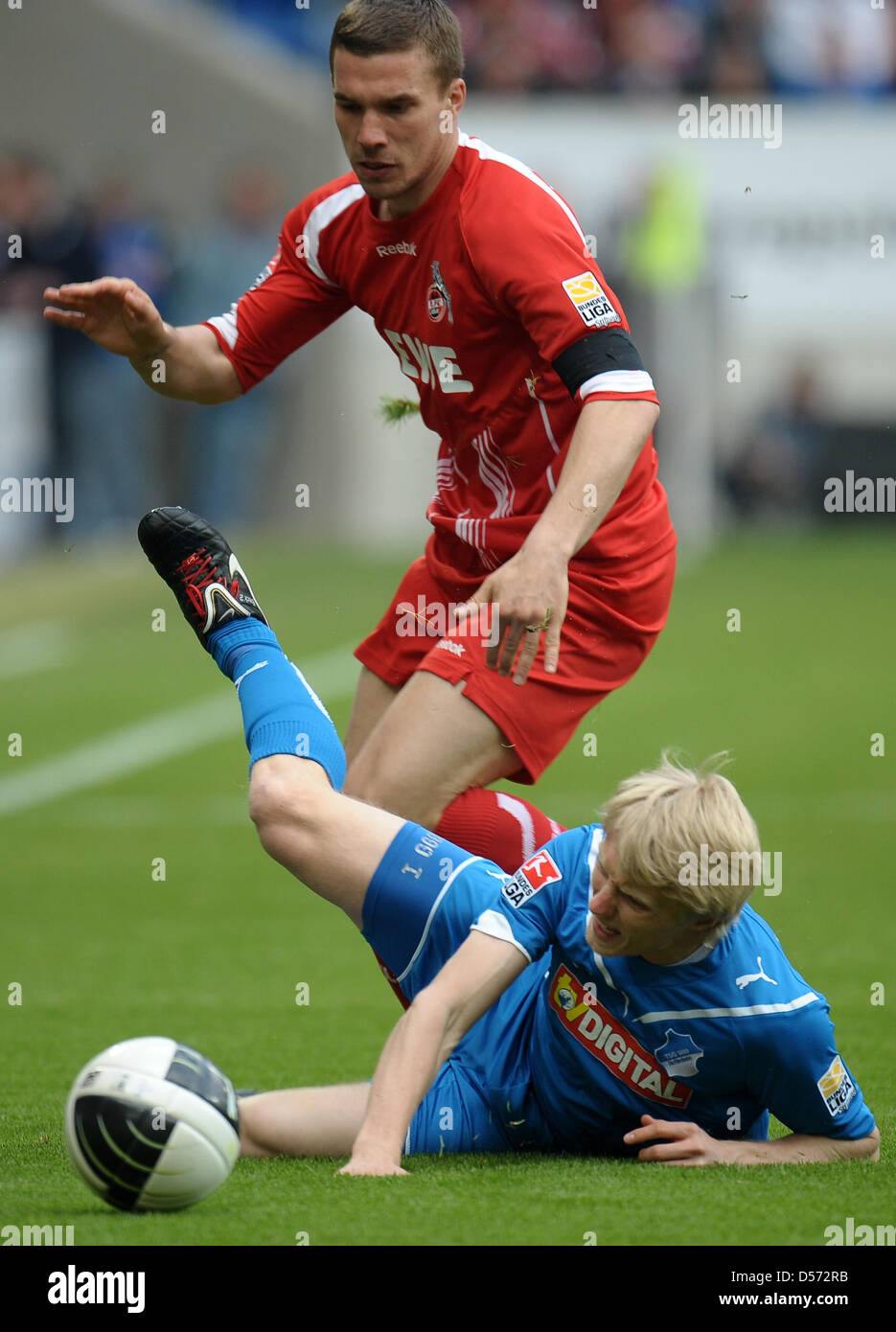 Cologne's Lukas Podolski wears a crape on his arm while he vies for the ball with Hoffenheim's Andreas Beck during German Bundesliga match TSG Hoffenheim vs Cologne at Rhein-Neckar-Arena in Sinsheim, Germany, 10 April 2010. The German National player and several others from Poland wore crapes during the matches. ''Since I was born in Poland and have a Polish heart, it is very sad a Stock Photo