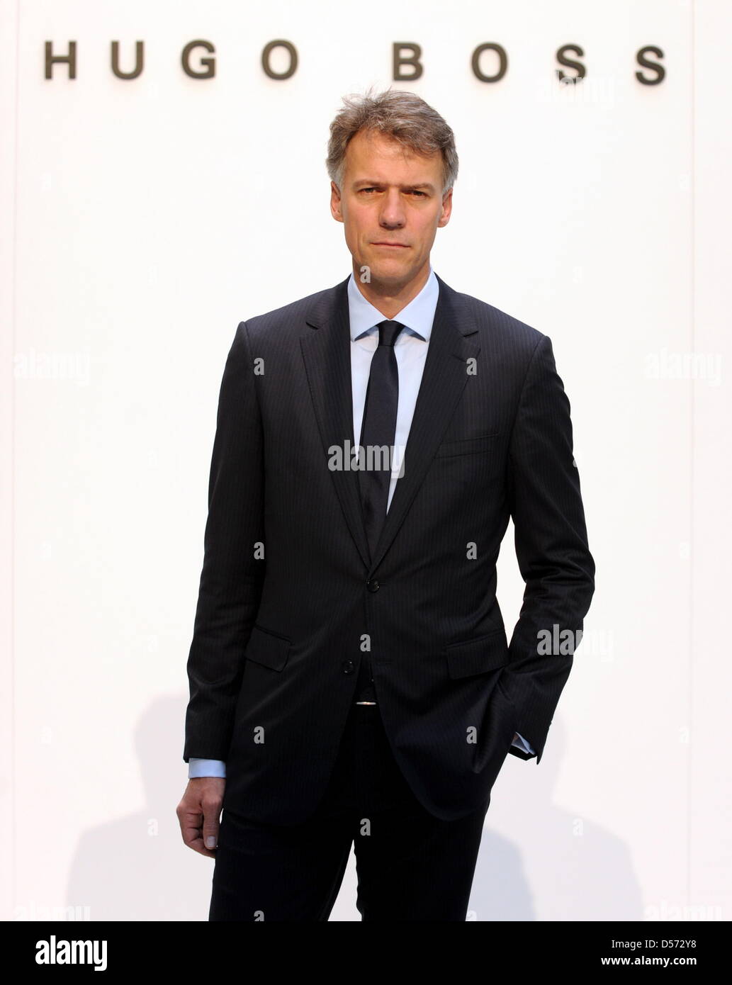 Claus-Dietrich Lahrs, CEO of fashion company Hugo Boss, stands in front of  the company logo at a balance press conference in the headquarters in  Metzingen, Germany, 12 April 2010. After the crisis