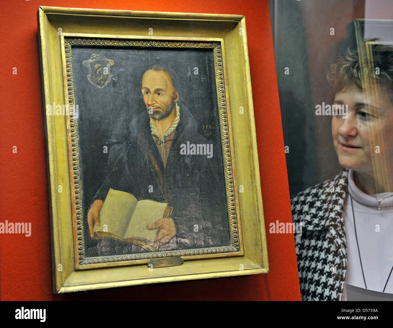 A woman looks at a painting of reformer Philipp Melanchthon of Lucas Cranach the Younger in his former house in Lutheranian city Wittenberg, Germany, 13 April 2010. This and many more exhibits are part of a special exhibit on the occaison of the 450 death anniversary of the scholar. The exhibit with the title ''New Treasures for Melanchthon'' will be opened on 16 April 2010 and beg Stock Photo