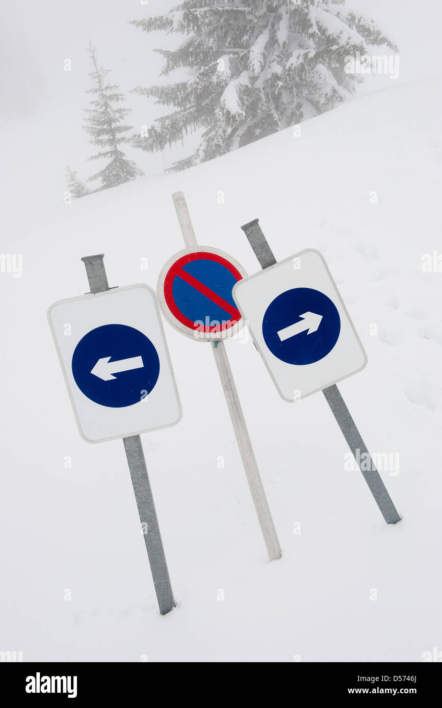 Signs indicating dead end in snow Stock Photo