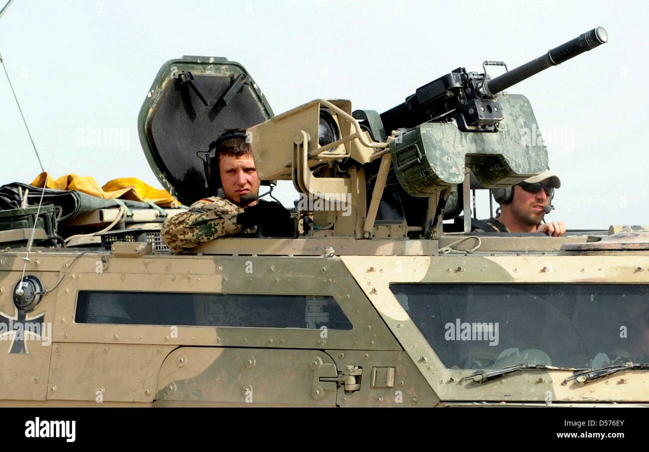 Soldiers drive with their vehicles at their camp in Kunduz, Afghanistan ...