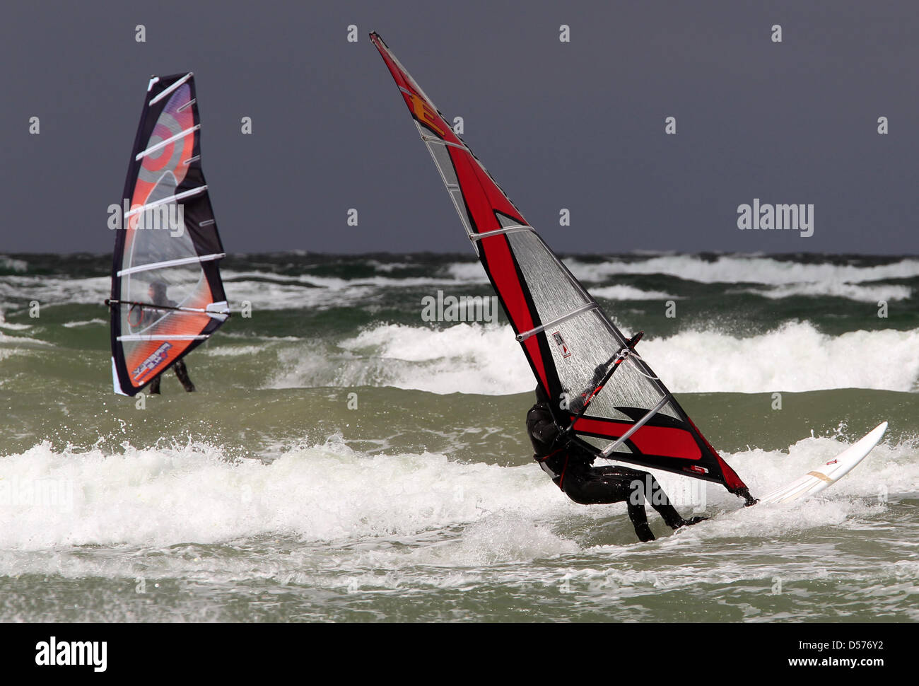Windsurfers use the heavy winds at the shore in Warnemuende, Germany