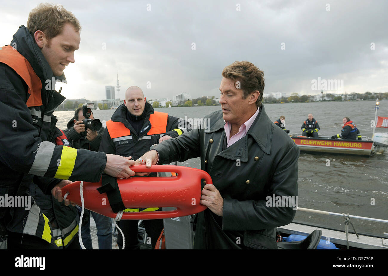 US actor David Hasselhoff signs a so-called Baywatch life buoy as he presents his autobiography 'Making Waves' in Hamburg, Germany, 21 April 2010. Hasselhoff's autobiography will be in German bookstores from 22 April on. Photo: FABIAN BIMMER Stock Photo