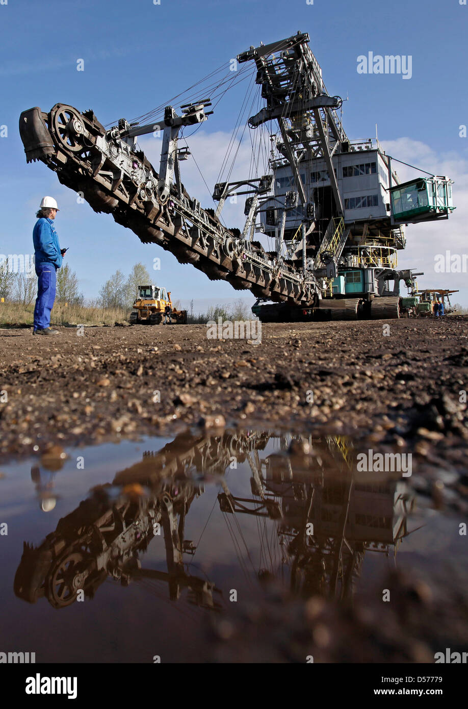 A 960-ton-heavy bucket-chain dredger crosses a street between Profen and Hohenmoelsen, Germany, 22 April 2010. The dredger is on the way to the brown coal district Schwerzau of the Profen surface mine. The dredger is 22 metres high and mines 1000 cubic metres of brown coal and waste material per hour. Photo: JAN WOITAS Stock Photo