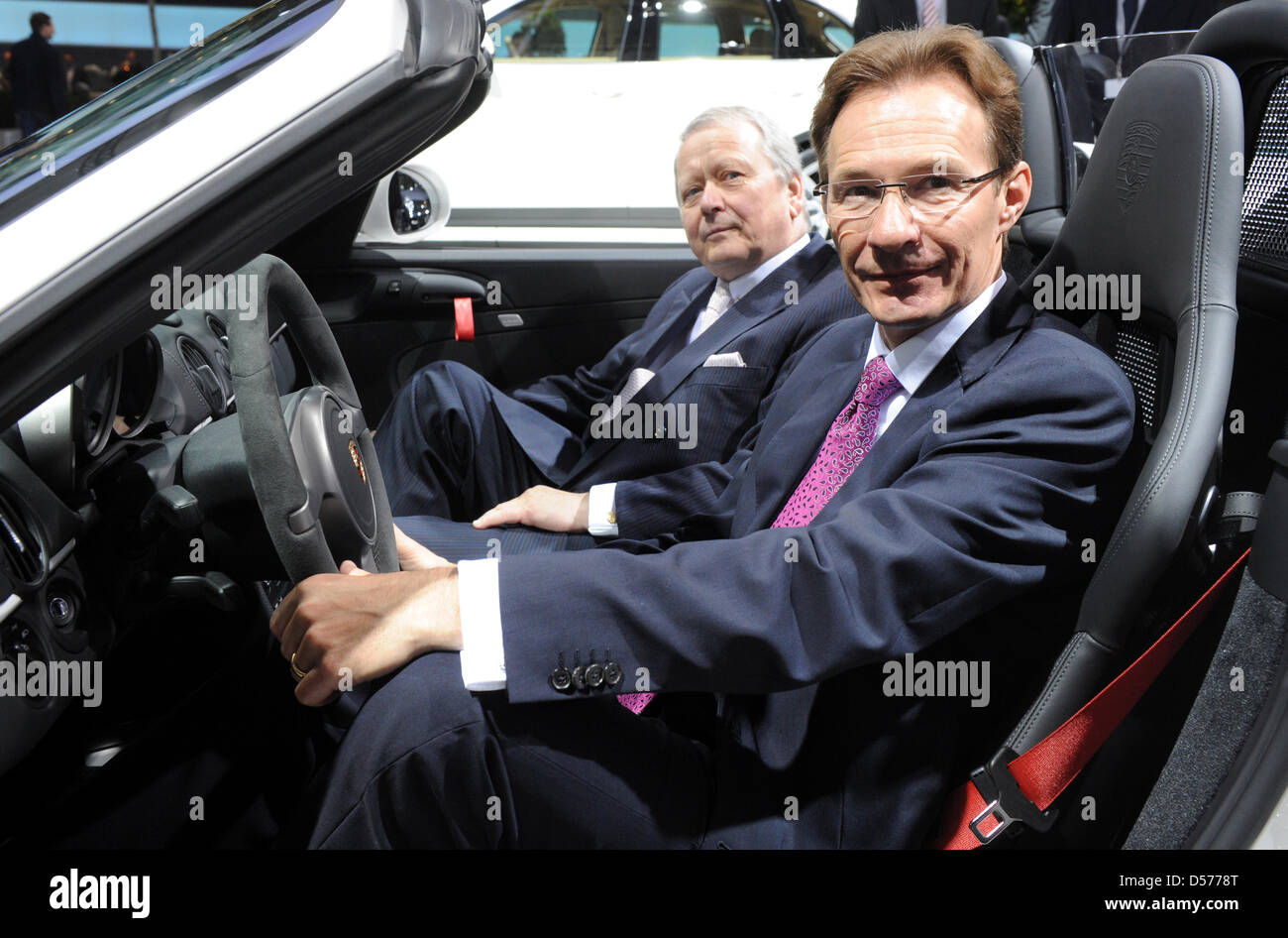 Michael Macht (R), CEO of Porsche AG, and Wolfgang Porsche, chairman of the Porsche supervisory board, sit in a Porsche Boxter Spyder prior to the general meeting of Volkswagen AG in Hamburg, Germany, 22 April 2010. Europe's largest automaker Volkswagen increased its profits in the first quarter of 2010. The earnings after taxes increased by nearly 95 per cent to 473 million euros, Stock Photo