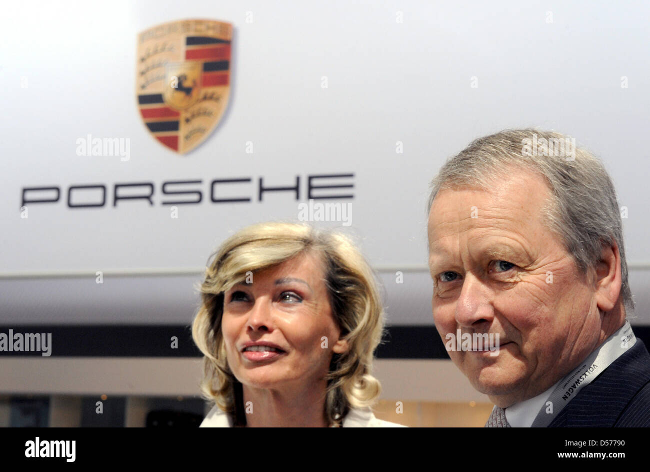 Wolfgang Porsche, chairman of the Porsche supervisory board, and his life partner Claudia Huebner pictured at the Porsche stand in the showroom prior to the general meeting of Volkswagen AG in Hamburg, Germany, 22 April 2010. Europe's largest automaker Volkswagen increased its profits in the first quarter of 2010. The earnings after taxes increased by nearly 95 per cent to 473 mill Stock Photo