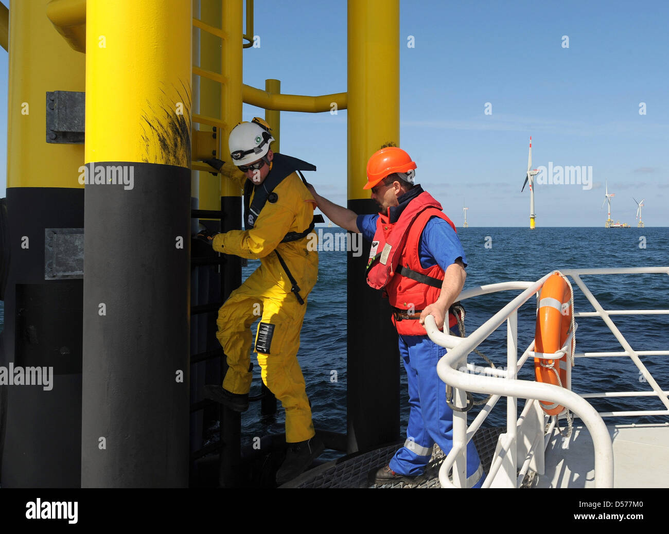 EWE network technician Rainer Juetting (L) and his colleague of 'Frisia' Sascha Reinert (R) seen onboard the maintenance ship 'Wind Lift 1' during a deployment at the offshore windpark 'Alpha Ventus' 45km off the coast of Borkum island, Germany, 23 April 2010. The park is the first of its kind in Germany and will officially be inaugurated on 27 April 2010. The joint venture between Stock Photo