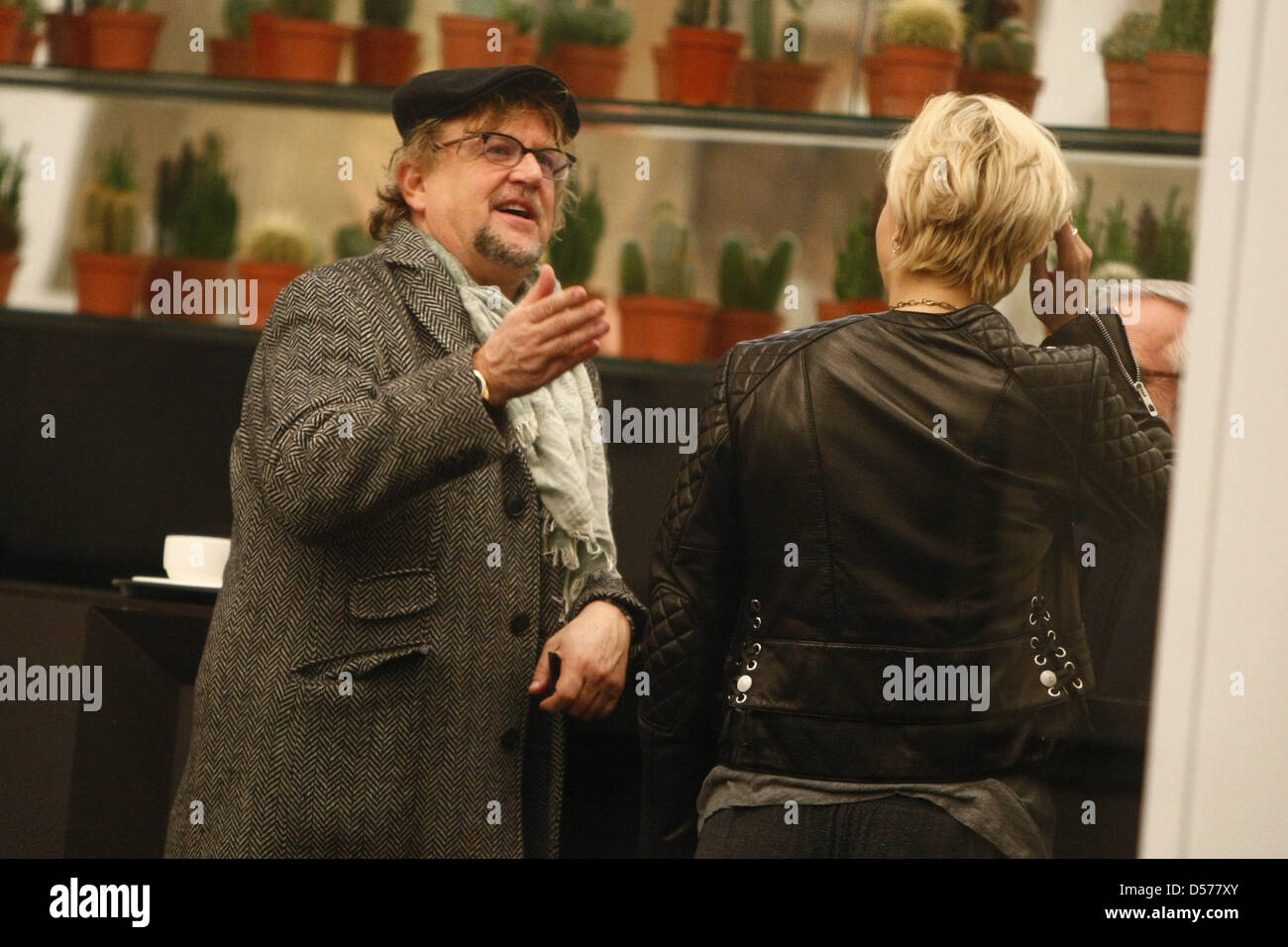 Martin Krug giving his expert opinion on how his girlfriend Verena Kerth looks in a new leather jacket which she's trying on at Stock Photo