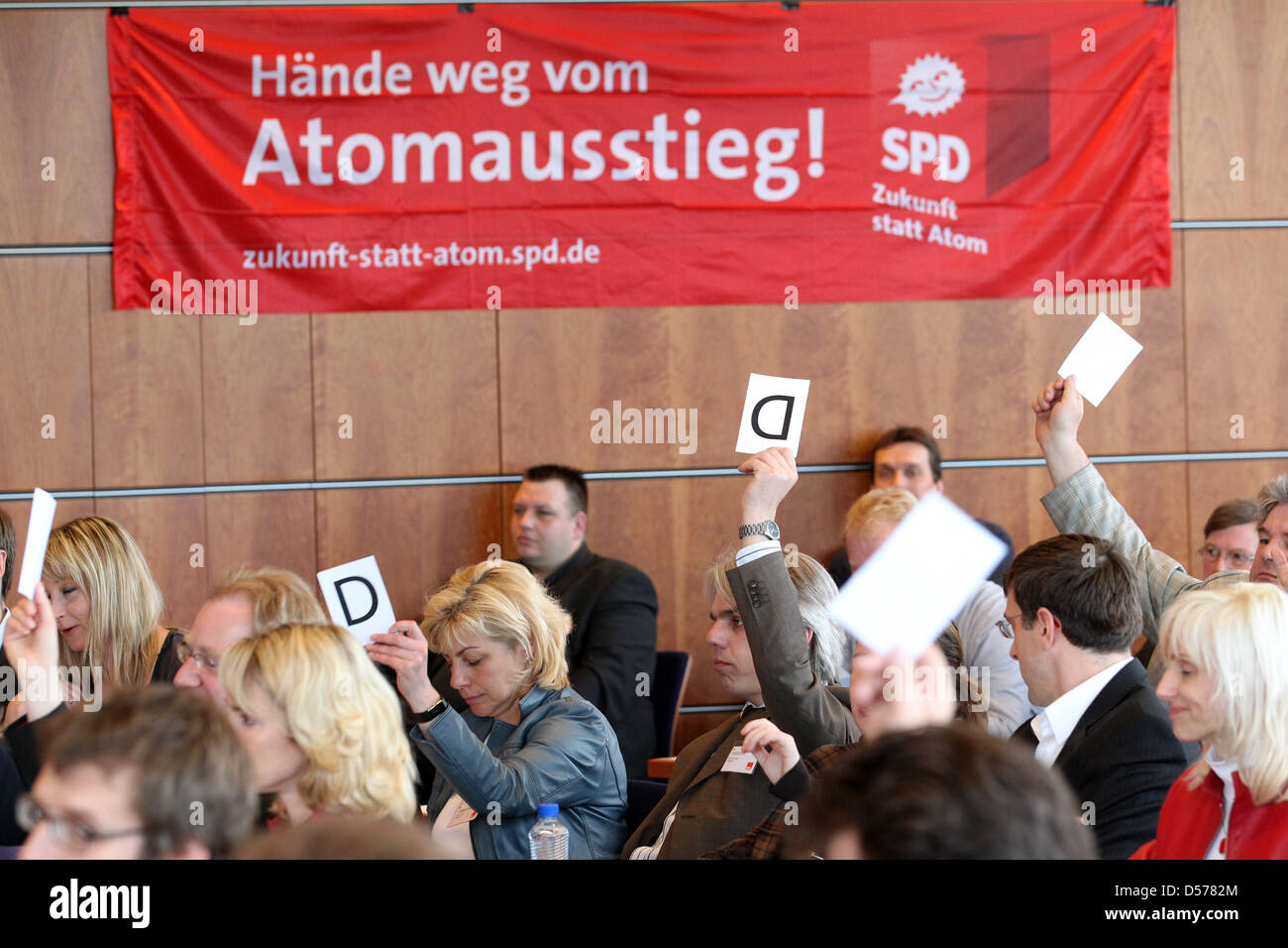 Participants of the Mecklenburg Western Pomerania's SPD party conference vote on a motion in Rostock, Germany, 24 April 2010. The 80 delegates discussed about the ground ideas of a new program. Main points are economy and job market, inprovement for children and families, education plus the securement of general interests of the country. Photo: Bernd Wuestneck Stock Photo