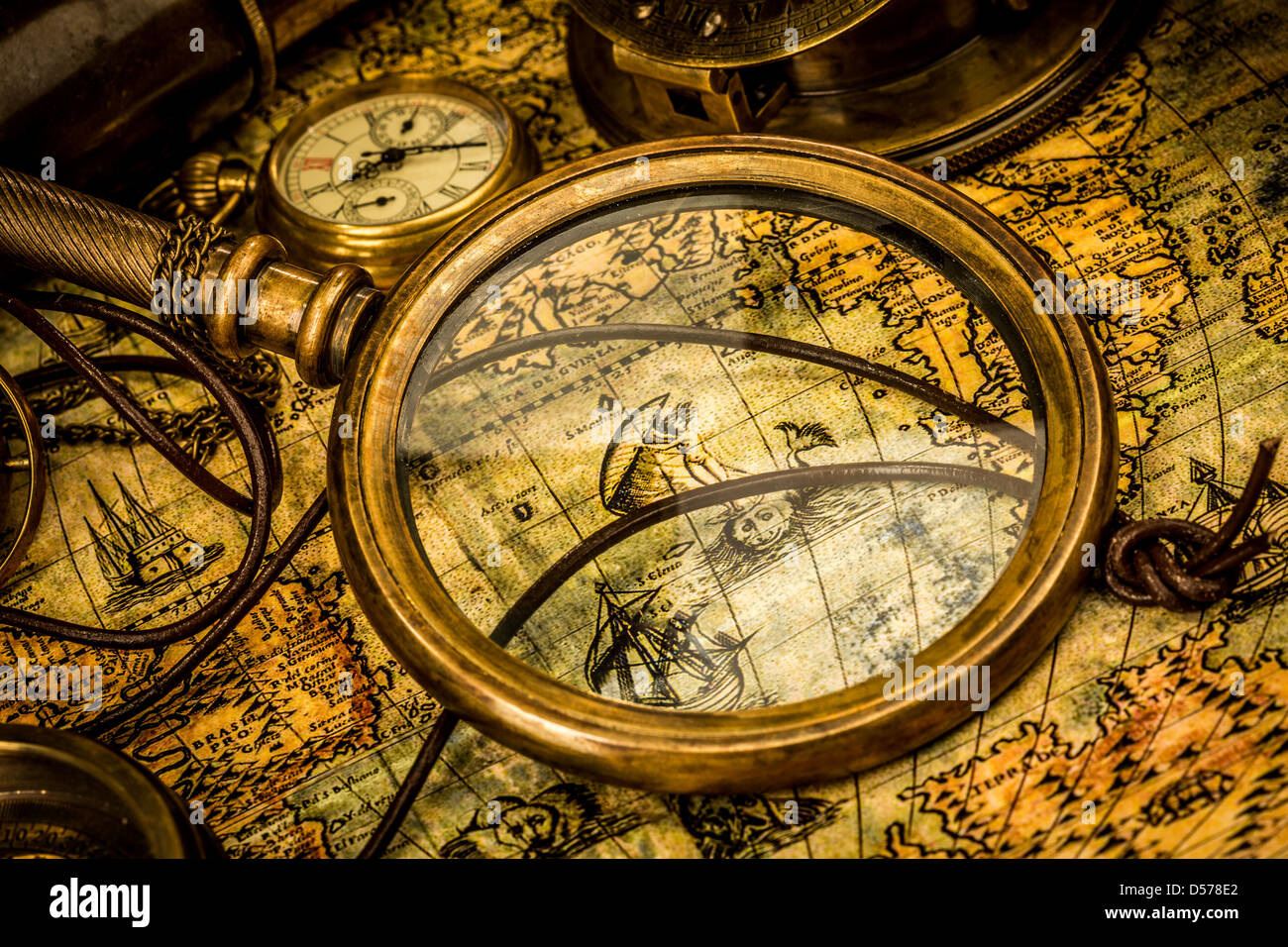 Vintage magnifying glass, compass, telescope and a pocket watch lying