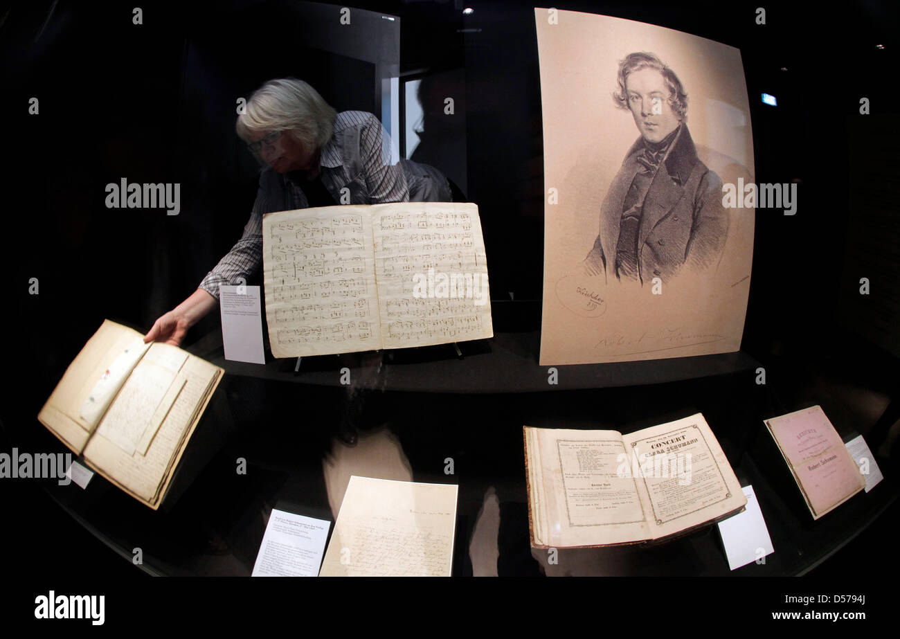 Musical scores, writings and the ''Acta Privata'' of the trial of Robert Schumann against the father of his bride Clara Wieck is held in to the camera by an employee of the University Library in Lepzig, Germany, 27 April 2010. In a small cabinet exhibit on the occasion of composer Robert Schumann's 200th birthday, the report is displayed. Schumann and his wife Clara Wieck forced th Stock Photo