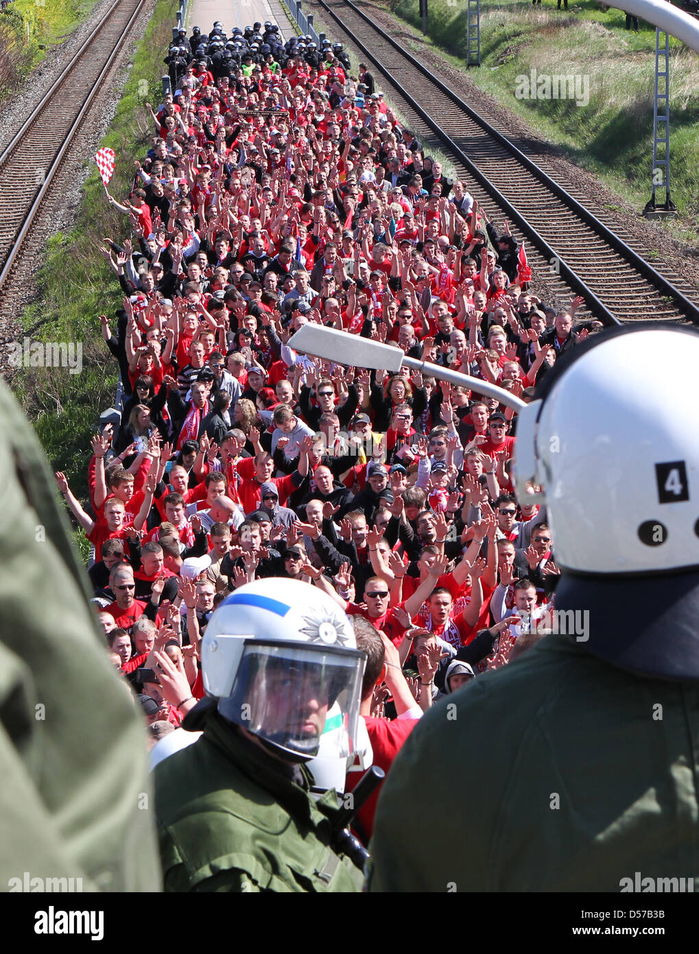 With a massive contingent, the police meet the 680 Cottbus' fans, which arrived with a train previous to German 2nd Bundesliga match FC Hansa Rostock vs Energie Cottbus at DKB-Arena in Rostock, Germany, 02 May 2010. The Police and the German Soccer Association (DFB) have classified the match between FC Hansa Rostock and Energie Cottbus as a high risk. Photo: BERND WUESTNECK Stock Photo