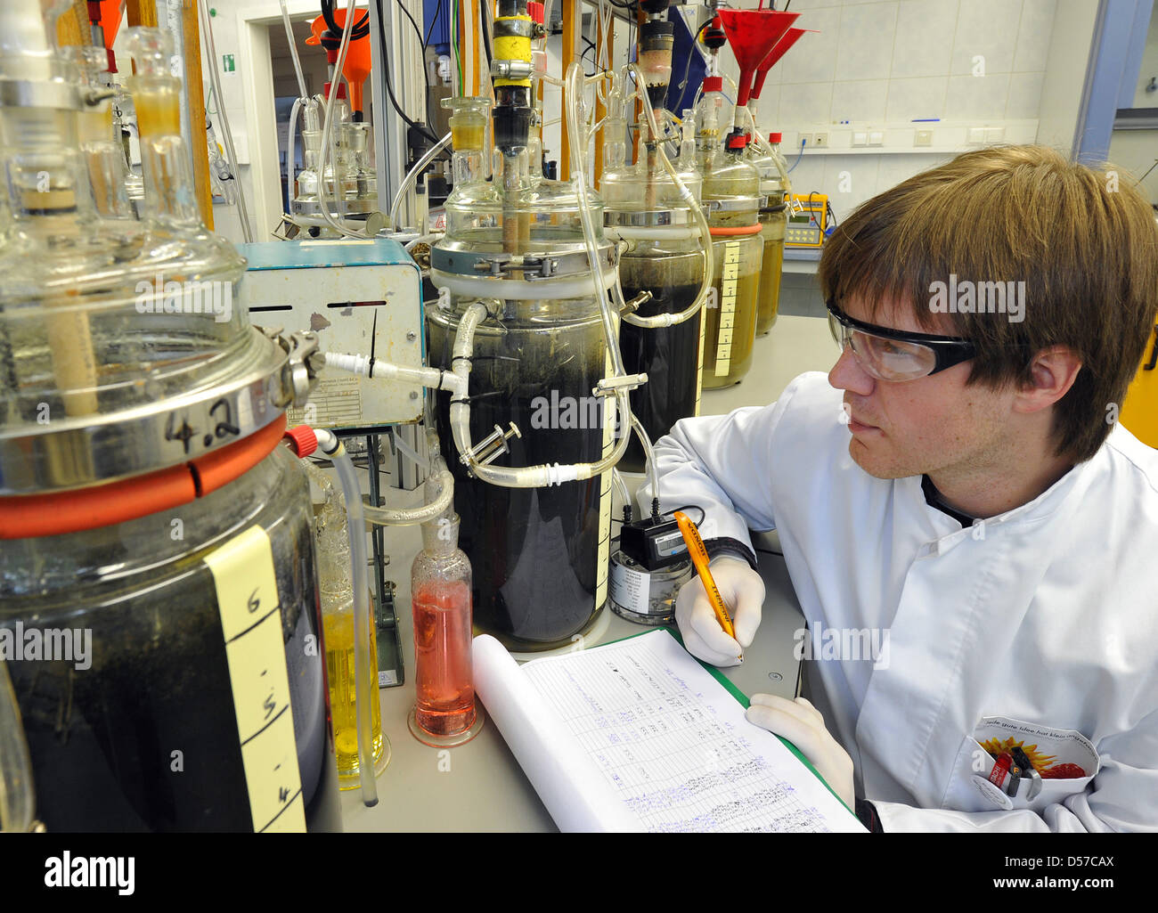Chartered engineer Matthias Mueller checks the amount of gas produced from slop in a laboratory of German Biomass Research Centre (DBFZ) in Leipzig, Germany, 04 May 2010. The research centre deals with the improvement of technological, economical and ecological efficiency of biogas production. Photo: Hendrik Schmidt Stock Photo