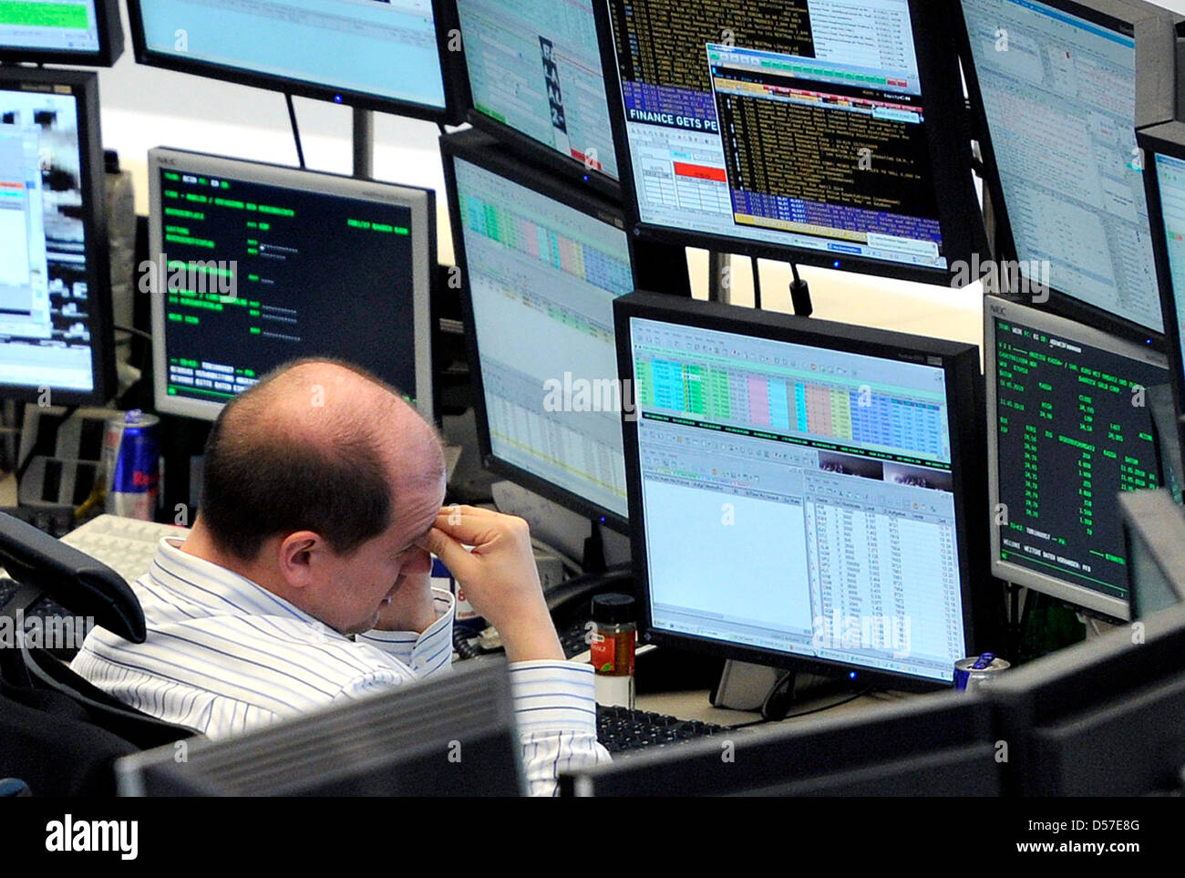 Broker Computer Screen A broker takes a look at his computer screens in the stock exchange in ...