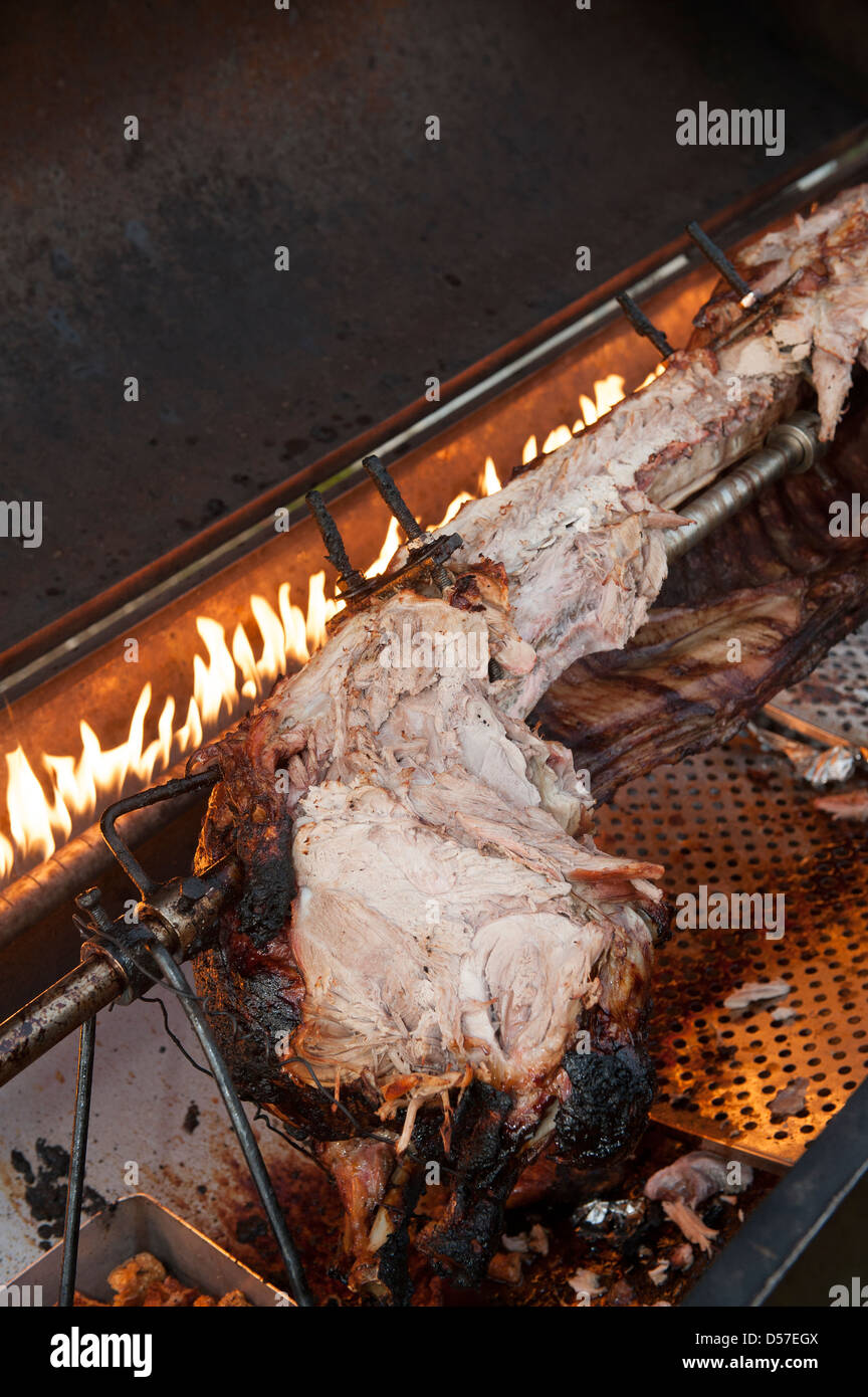 Remains of a hog roast being cooked on a spit. Stock Photo