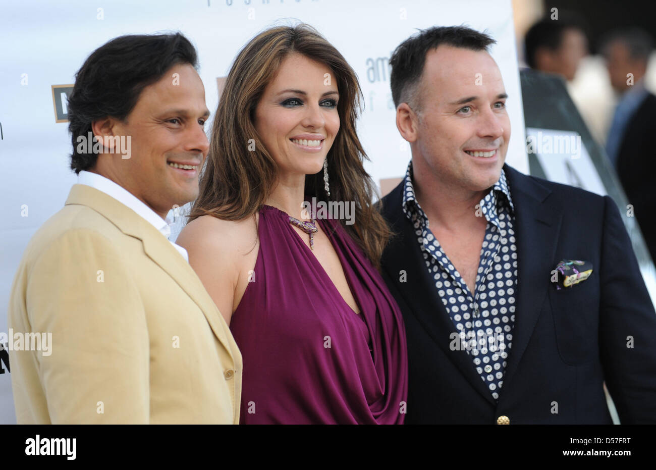 British actres and model Liz Hurley (C), her husband Arun Nayar (L) and Elton John's husband David Furnish (R) attend a fashion show by Amber Lounge in Monte Carlo, Monaco, 14 May 2010. Photo: Peter Steffen Stock Photo