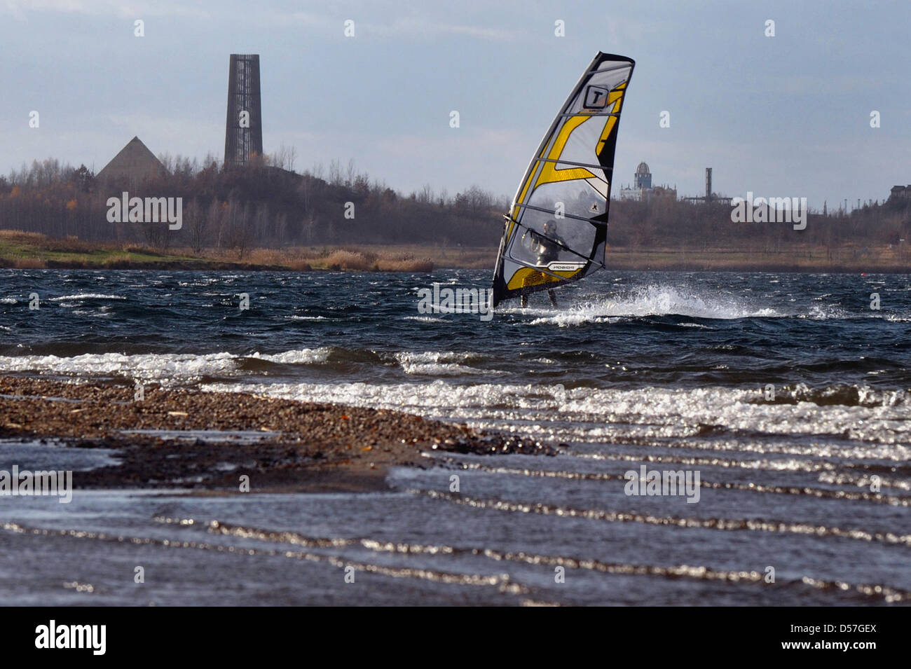 A surfer on lake 'Cospudener See' in Markkleeberg to the south of Leipzig, Germany, 27 November 2009. The lake is one of many which were formed by flooding former surface mining holes. Saxony's government is currently assessing whether to allow motor boats on the lake or not, an adminstrative procedure dubbed 'Erklaerung der Schiffbarkeit'. Environmental protection organisations st Stock Photo