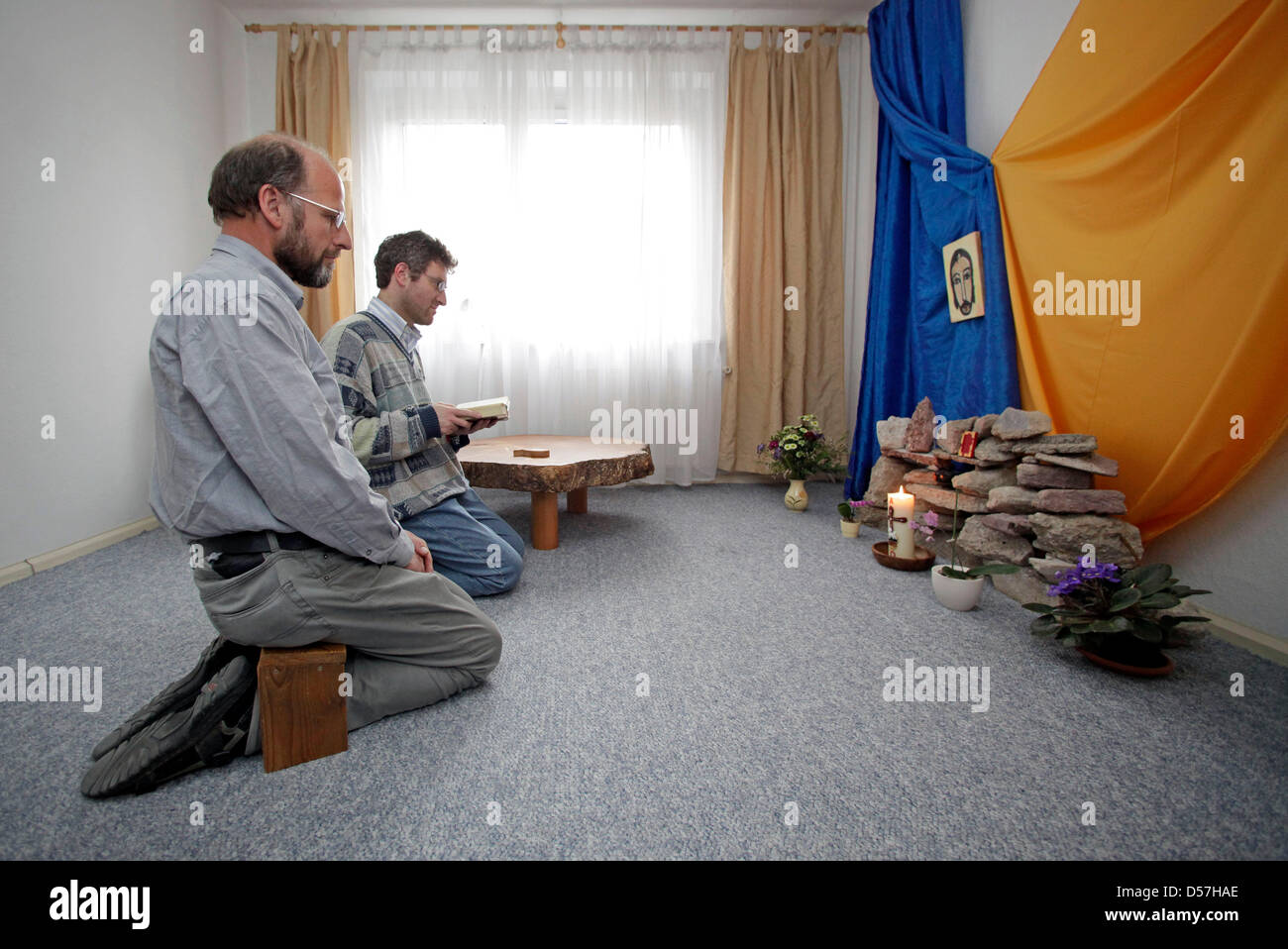 Brothers Andreas (L) and Gianluca (R) of the order 'Little Brothers of the Gospel' pray in a flat of a Plattenbau, a building made with precast concrete slabs, in Leipzig, Germany, 27 April 2010. The order is accepted since 1968. Photo: Jan Woitas Stock Photo