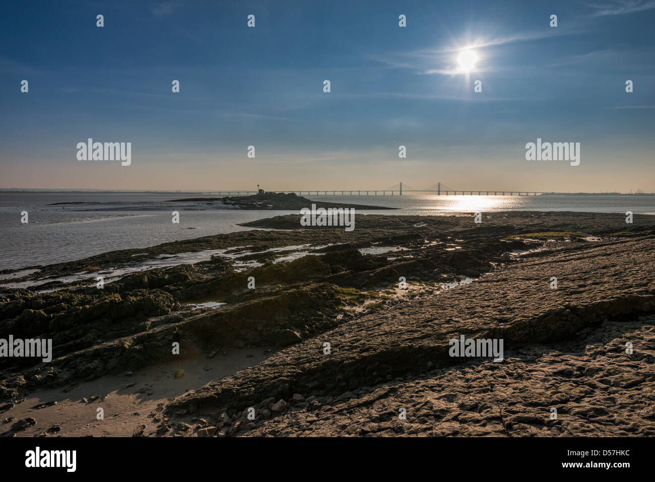 , SECOND SEVERN CROSSING,NEW SEVERN BRIDGE FROM SEVERN BEACH WITH REFLECTED SUN. Stock Photo