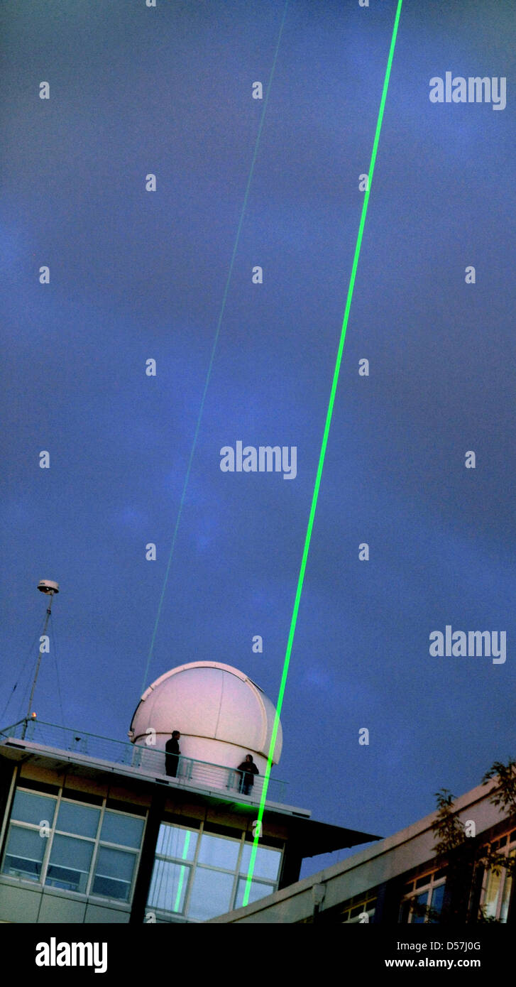 In the night sky, Scientists watch two laser beams, which help to document measurement results of ash cloud of volcano Eyjafjallajoekull in Iceland at Leibniz Institute for Tropospheric Research in Leipzig, Germany, 17 May 2010. The data of the ash cloud is called by several international research groups, among them the German Meteorological Service Provider and the Centre for meas Stock Photo