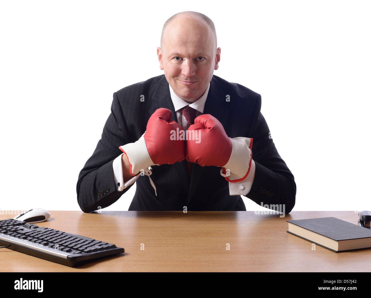 Stock image of person wearing business suit and boxing gloves isolated on white Stock Photo