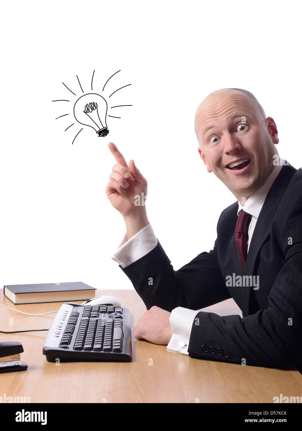 Businessman sitting at his desk with a good idea isolated on white Stock Photo