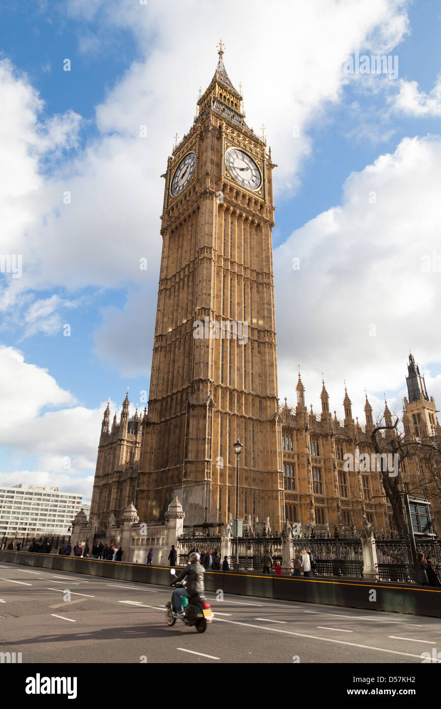 A scooter passing Big Ben viewed from outside Westminster underground station Stock Photo