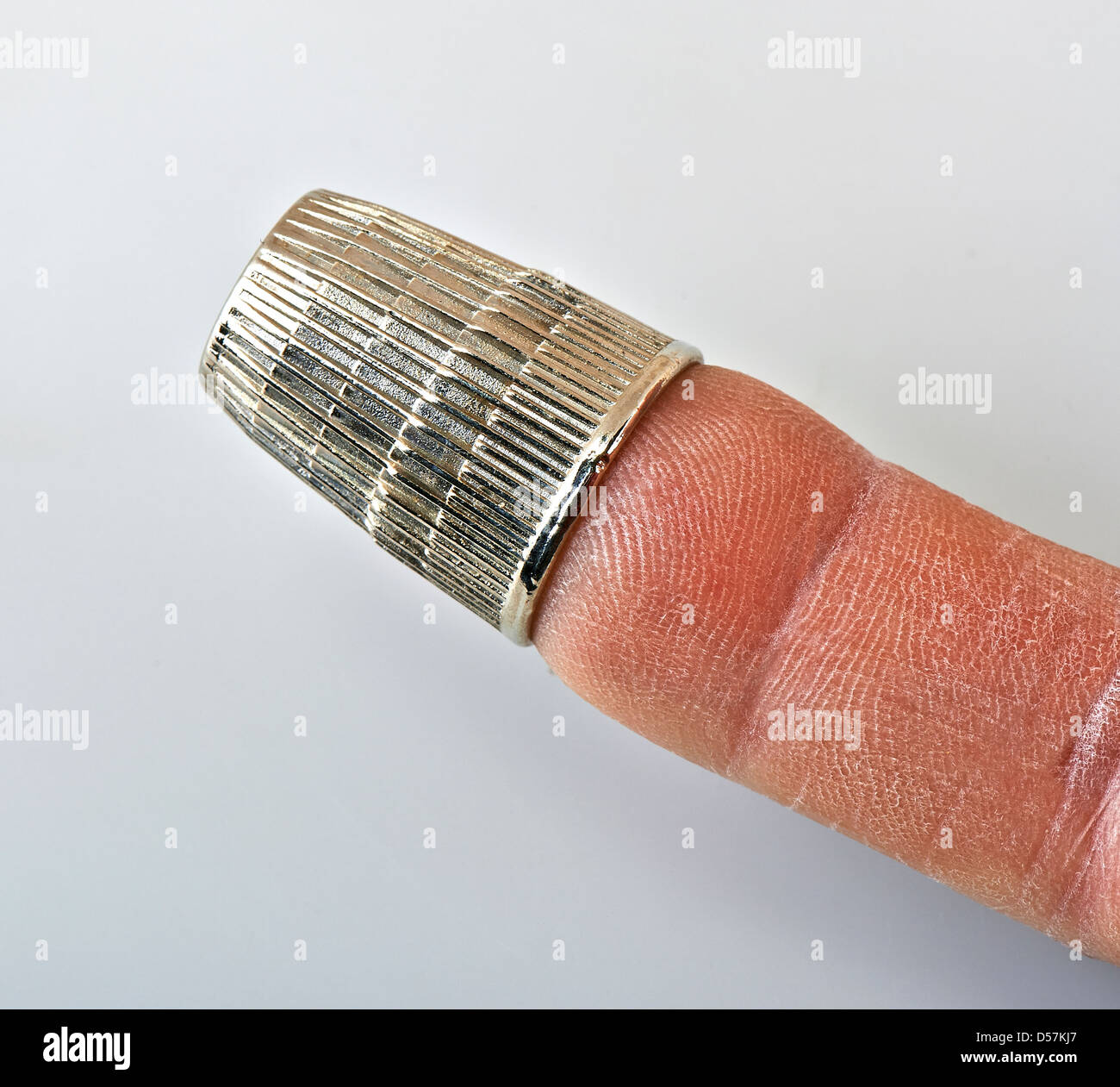 thimble on finger Stock Photo Alamy