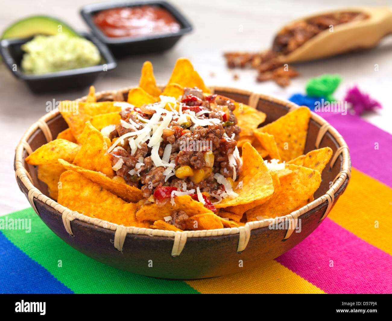 a bowl with spicy tortilla chips served with minced meat and cheese Stock Photo
