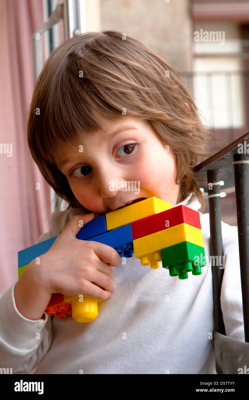 Healthy four year old boy with make believe pistol made from Lego bricks  Stock Photo - Alamy