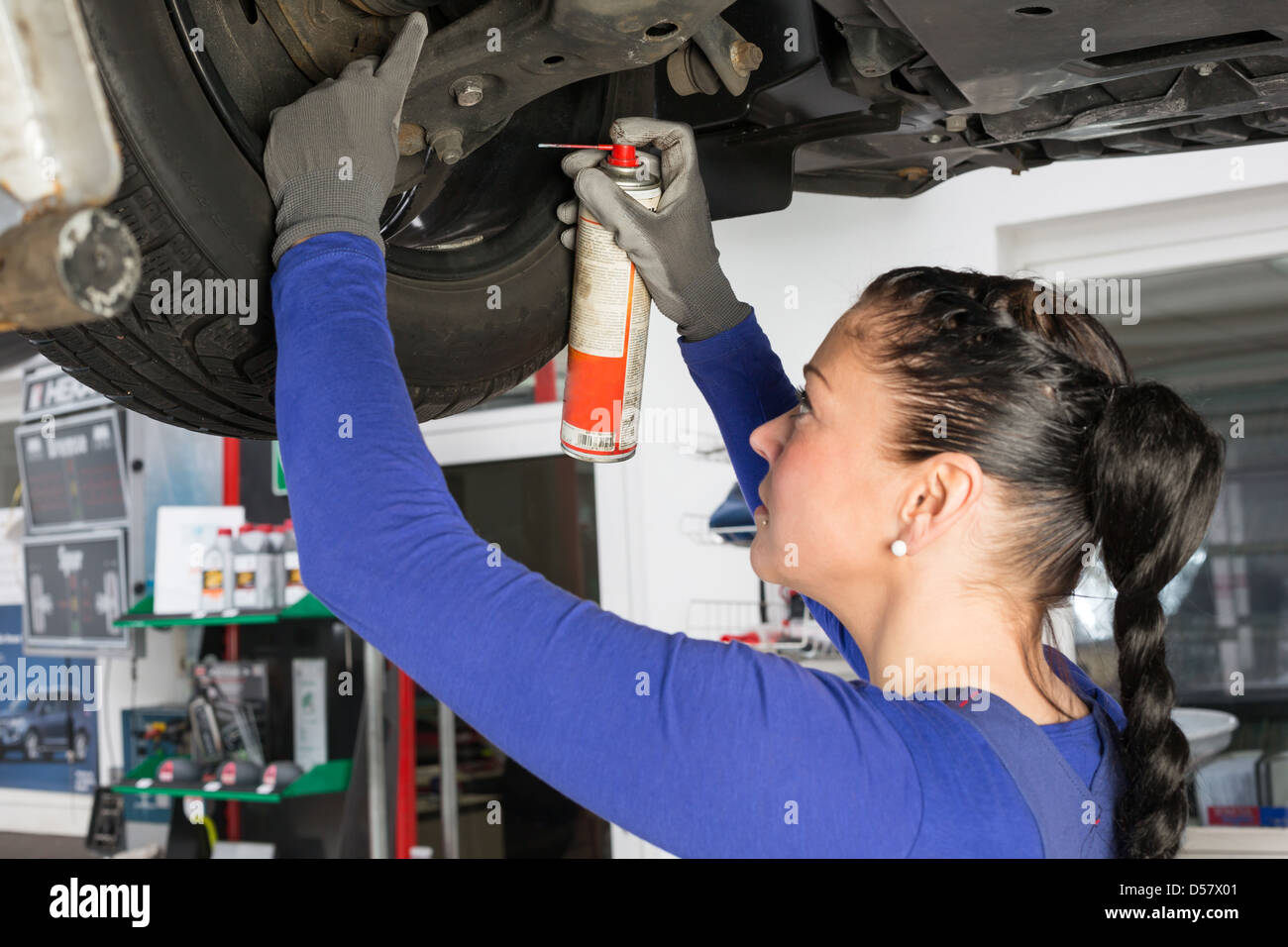 Car mechanics repairing a car on hydraulic lift Stock Photo Alamy