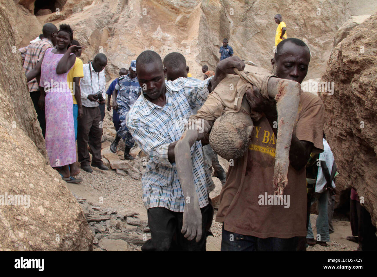 Body of boy who died in quarry being carried by peasants after it was dug from rubble in Lira town, Northern Uganda. Stock Photo