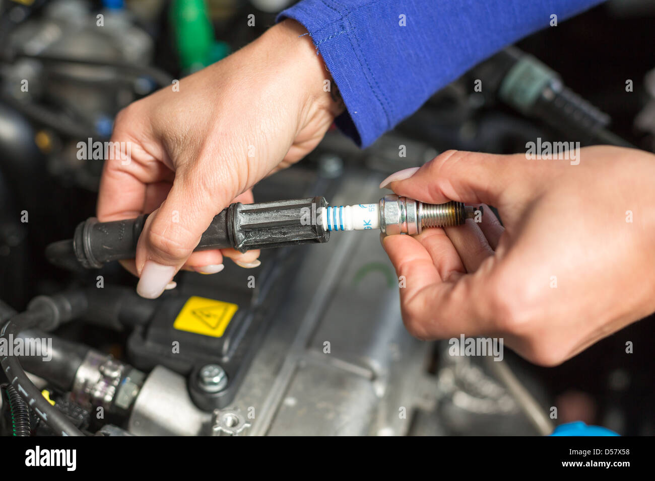 A car mechanic changing spark plugs Stock Photo Alamy