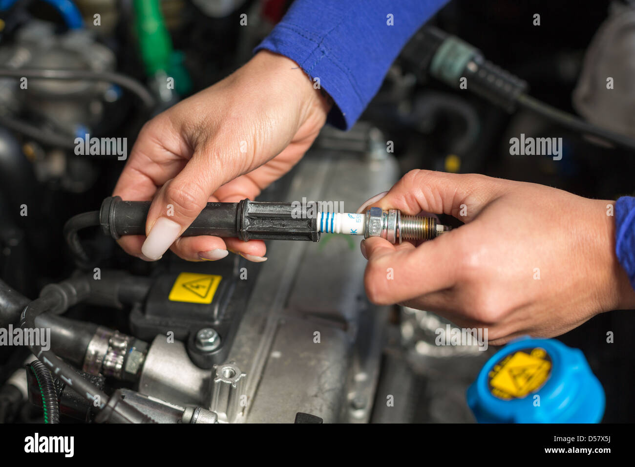 A car mechanic changing spark plugs Stock Photo Alamy
