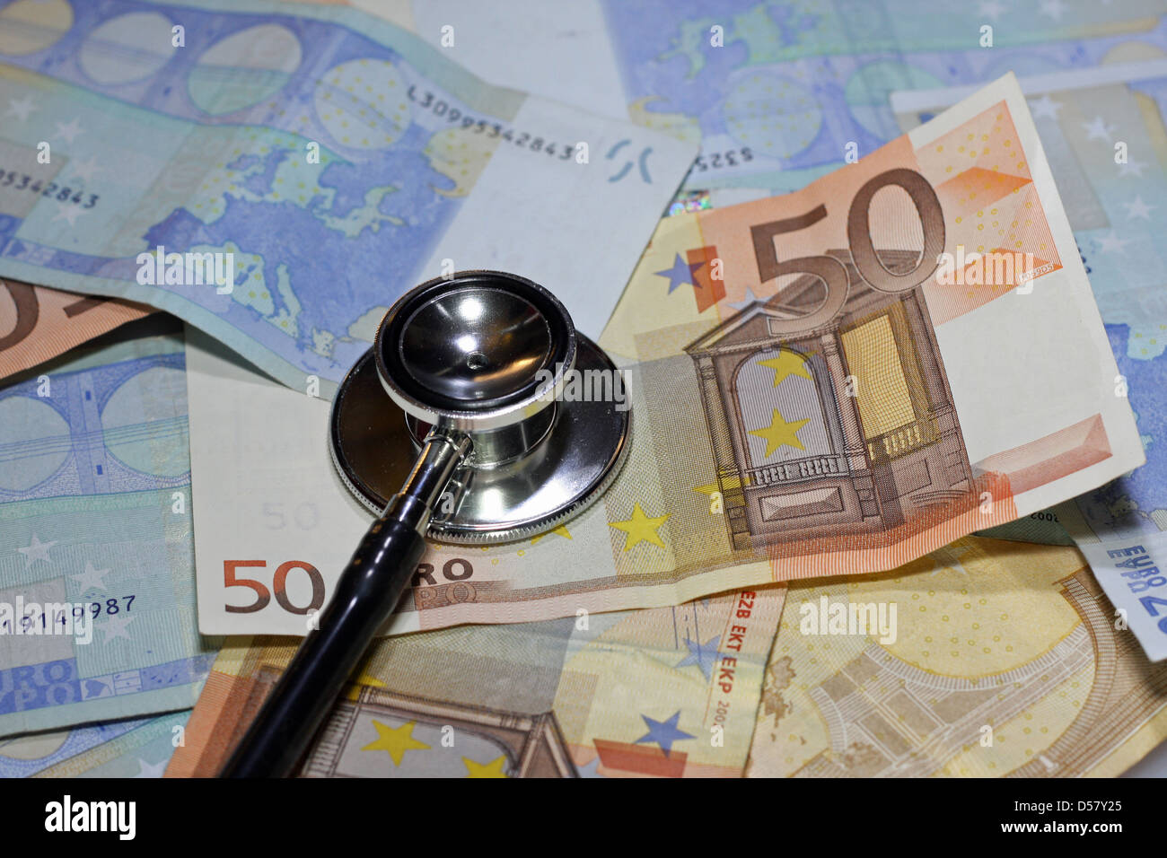 stethoscope doctor leaned on many sick euro currency banknotes Stock Photo
