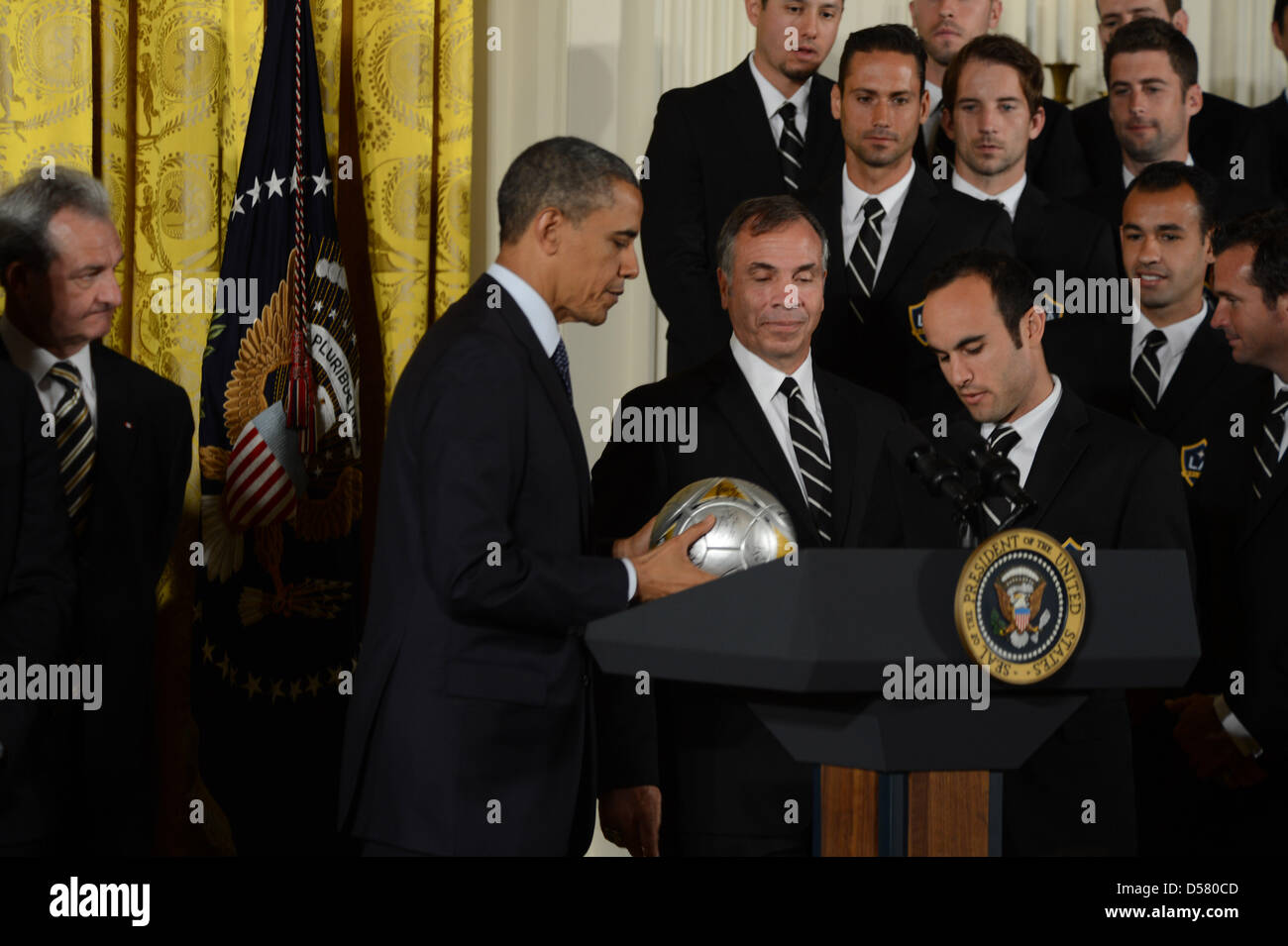 Washington, DC, USA. 26th March, 2013. The White House-Washington DC..President Barack Obama welcomes the Stanley Cup champion Los Angeles Kings and the Major League Soccer champion LA Galaxy to the White House to honor their 2012 championship seasons in a ceremony in the East Room.He accepts a soccer ball and jersey from the LA Galaxy team..photo:   - ImageCatcher News(Credit Image: Credit:  Christy Bowe/Globe Photos/ZUMAPRESS.com/Alamy Live News) Stock Photo