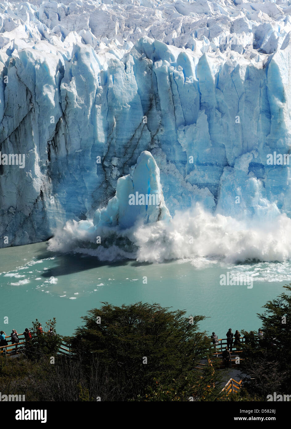 A tower of ice collapses from the face of the Perito Moreno Glacier  into Lake Argentina. Stock Photo