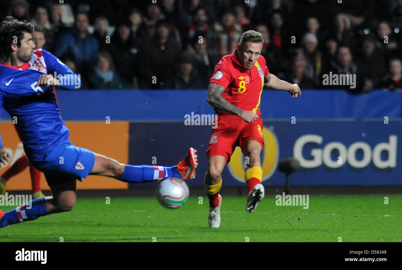 Swansea, UK. 26th March, 2013. FIFA 2014 World Cup Qualifier - Wales v Croatia .   Craig Bellamy of Wales fires past Vedran Corluka of Croatia as he shoots for goal. Stock Photo