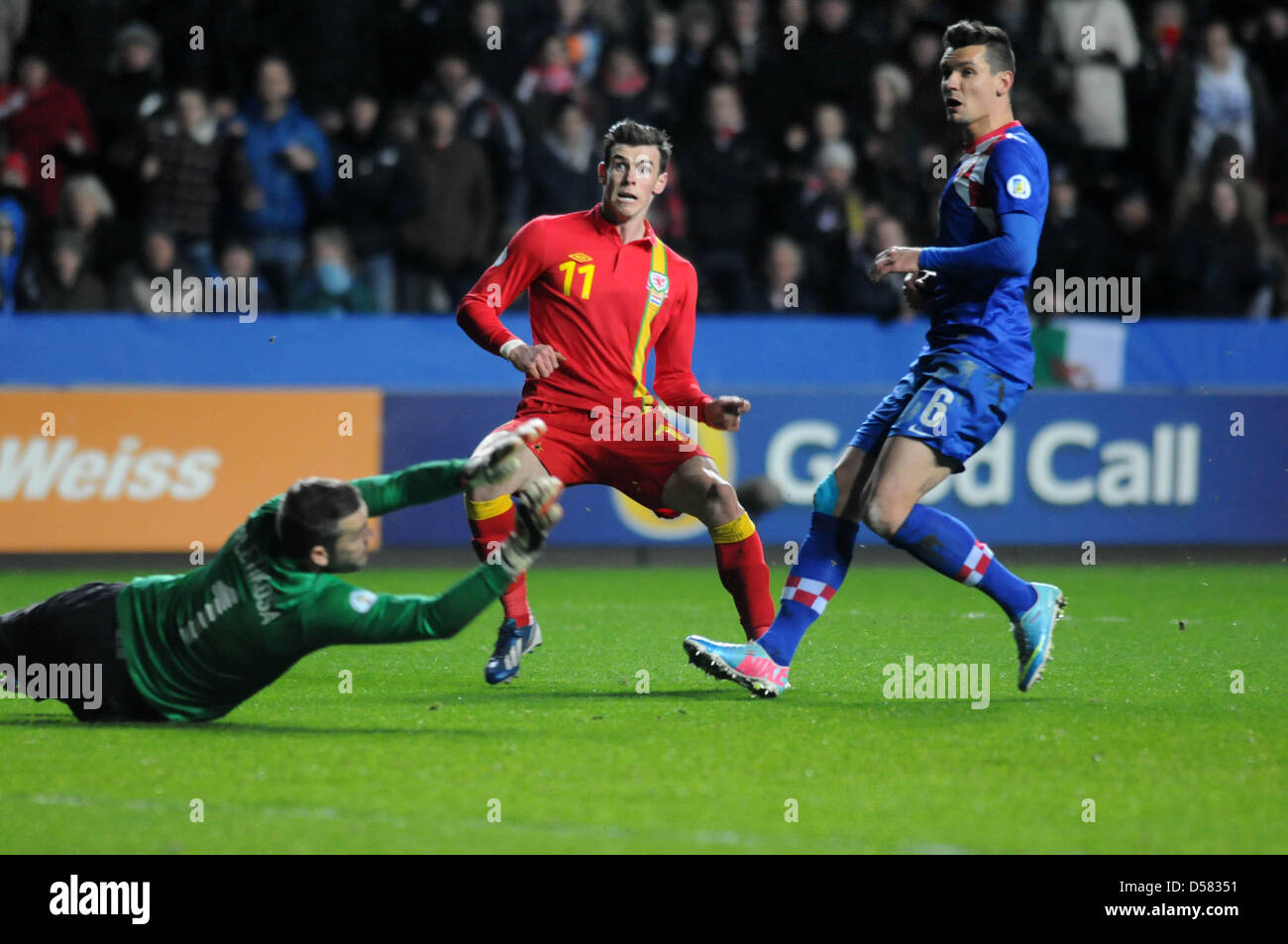 Swansea, UK. 26th March, 2013. FIFA 2014 World Cup Qualifier - Wales v Croatia .  Wales Gareth Bale fires past Croatia goalie Stipe Pletikosa. Stock Photo