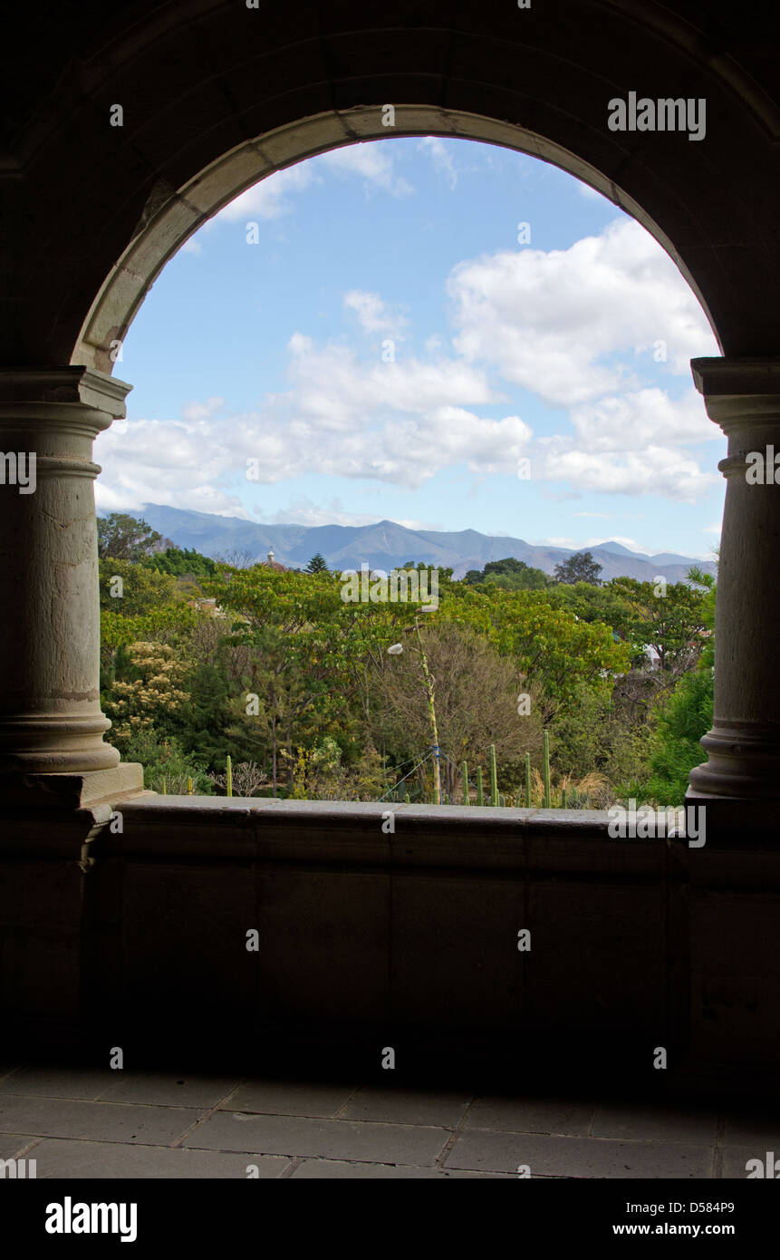 Looking out from an open porch in the Centro Cultural Santo Domingo over the Jardín Etnobotánico to the distant mountains. Stock Photo