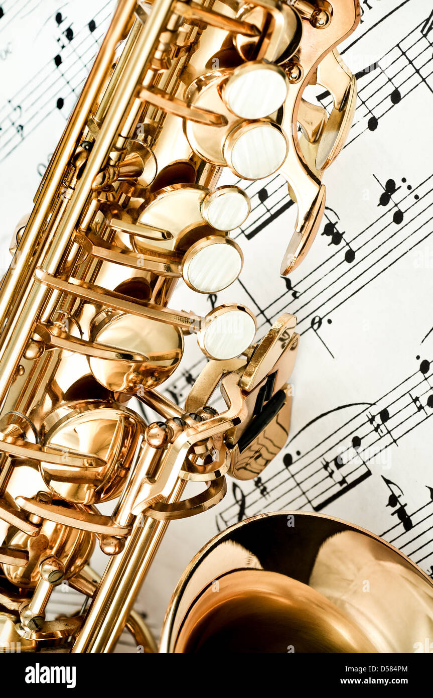 Saxophone keys closeup over score Stock Photo