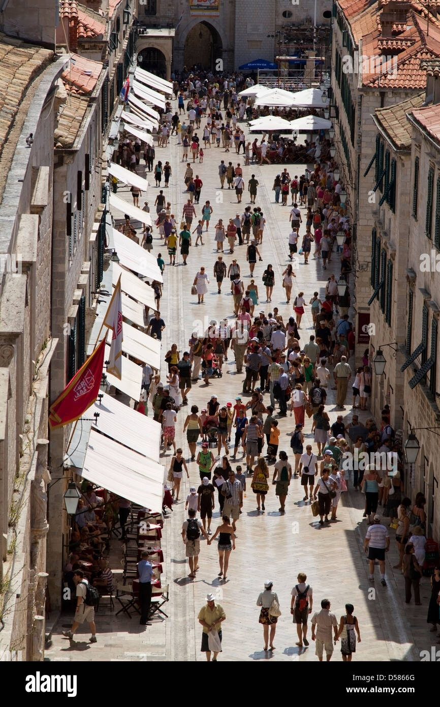 Tourists walk along the Stradun in Dubrovnik old town, Croatia Stock Photo