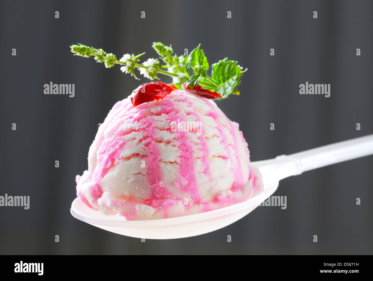 Scoop of cherry ice cream on spoon Stock Photo