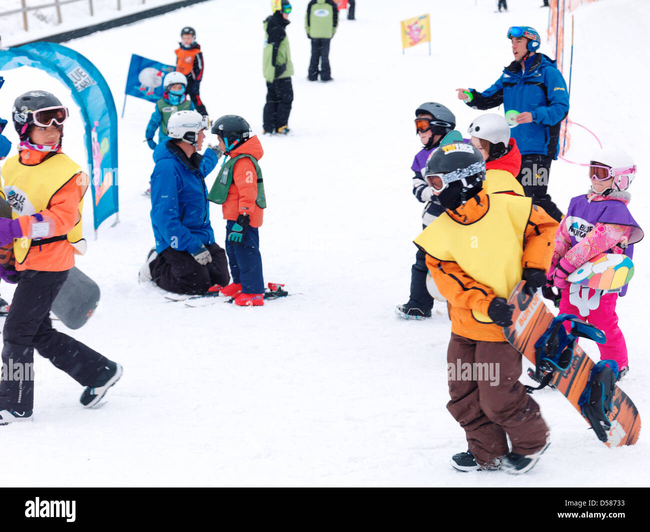 Children learning snowboarding and skiing at Blue Mountain, Collingwood, Ontario, Canada ski resort. Stock Photo