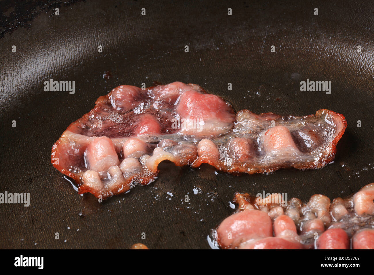 Pan roasted rashers of bacon - detail Stock Photo