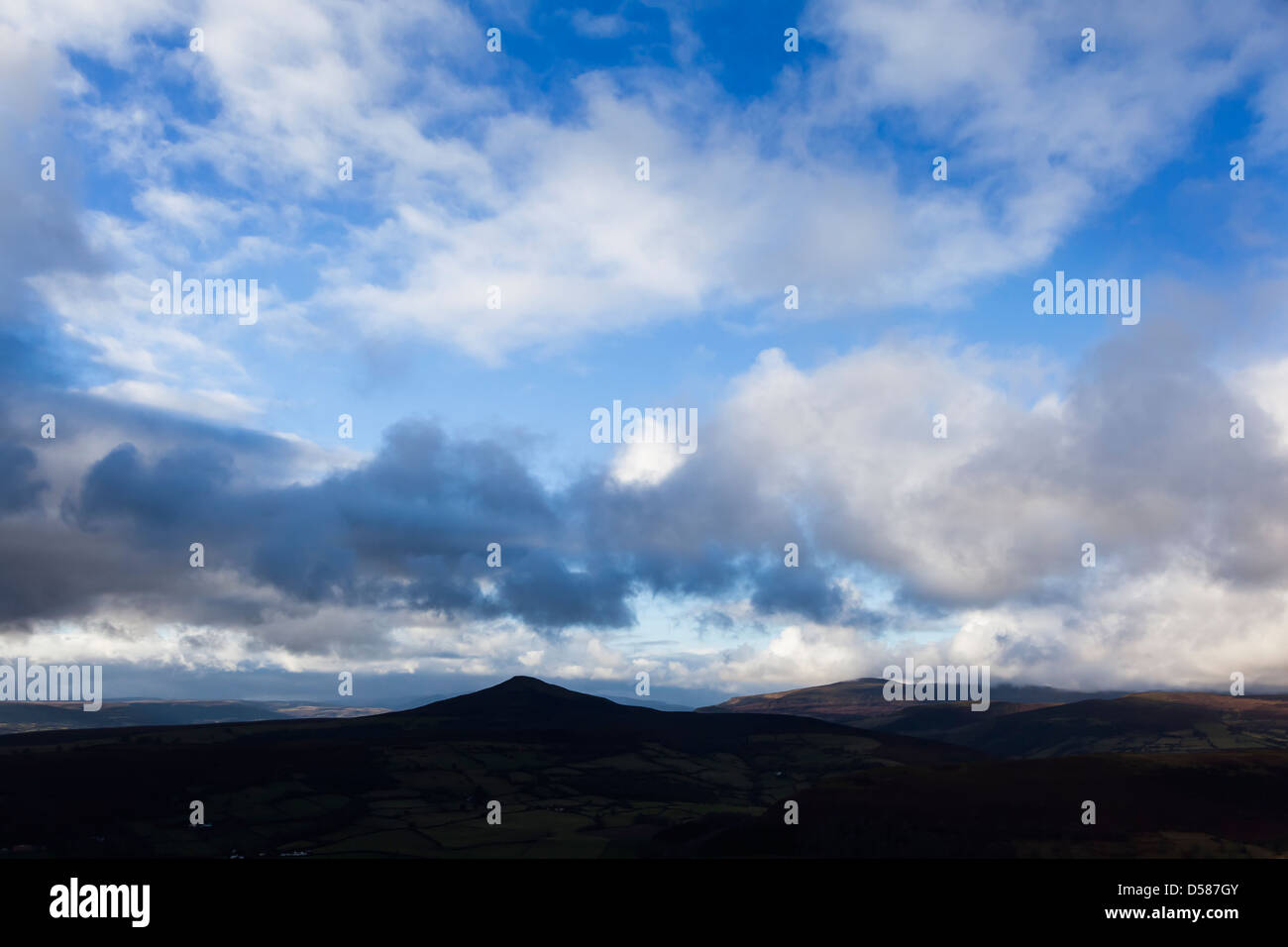 Sugar Loaf mountain in silhouette with clouds, Wales, UK Stock Photo